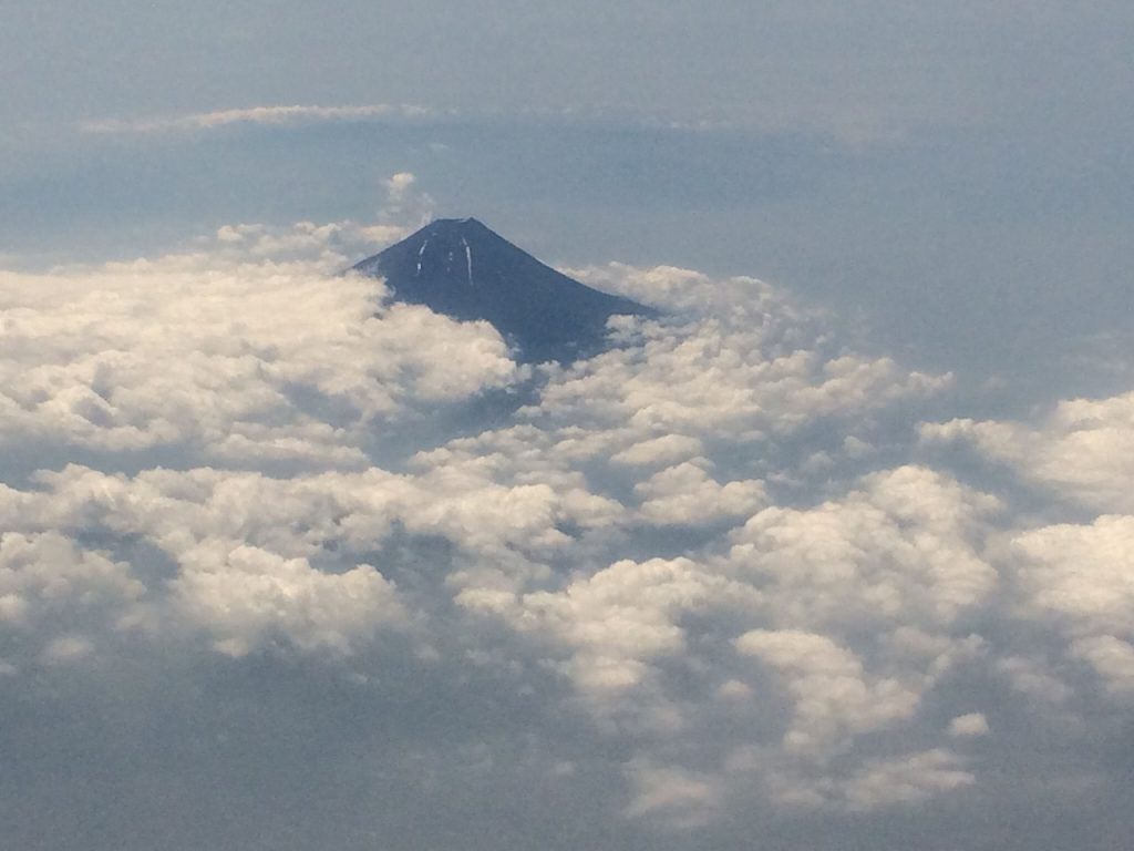 Mt. Fuji sticking out above the clouds at dusk